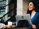 Smilende kvinde bag en pc