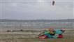 Stranden ved Ebeltoft med flere kitesurfere på stranden og en enkelt i havet.