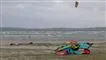Stranden ved Ebeltoft med flere kitesurfere på stranden og en enkelt i havet.