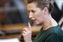 Statsminister Mette Frederiksen med alvorlig mine og en løftet pegefinger hun ses i profil