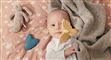 en baby med en blå elektronisk tingest ved siden af sig