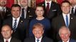 Mette Frederiksen og Donald Trump. Billedet er beskåret fra det store gruppefoto der blev taget under topmødet. Mette Frederiksen sidder lige bag en storsmilende Donald Trump. Ved siden af Trump ses prins Charles. 