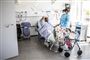 Læge tilser patient på hospitalsstue.