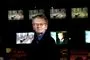 Poul Martinsen kigger ind i kameraet med tv-skærme i baggrunden