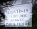 skilt med påskriften: Covid-19 vi holder lukket indtil videre
