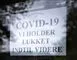 skilt med påskriften: Covid-19 vi holder lukket indtil videre