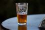 Et halvfyldt glas øl på et bord
