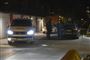 Politibiler og politifolk ved en garage