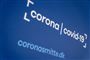 billede af skilt, hvor der står corona covid-19