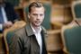 En yngre mand med overskæg i Folketinget