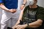 mand får vaccine i skulderen