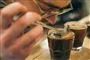 En mand dufter til en kop kaffe
