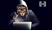 En mand i hættetrøje og maske taler med en åben laptop foran ham