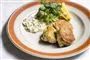 Tre fiskefrikadeller på en tallerken med remoulade og citron.
