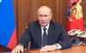 vladimir putin sidder i mørk jakke