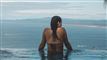 kvinde i pool ser ud over havet