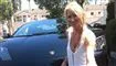 En blond kvinde ved en Lamborghini