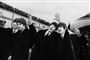 De fire medlemmer af The Beatles i sort hvid.