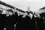 De fire medlemmer af The Beatles i sort hvid.