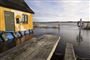 Sandsække kan være et sidste værn mod oversvømmelser, som ventes i weekenden. (Arkivfoto fra oversvømmelse ved Roskilde Fjord.)