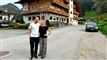 to glade personer foran et hotel