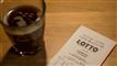 en lottokupon og en kop kaffe på et bord