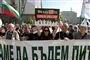 folkemasse demonstrerer bag et stort banner
