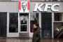 En mand går forbi facaden på en KFC-restaurant