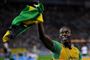 Bolt fejrer VM-titel og verdensrekord ved at vise sit lands flag
 Foto: Gero Breloer / POLFOTO